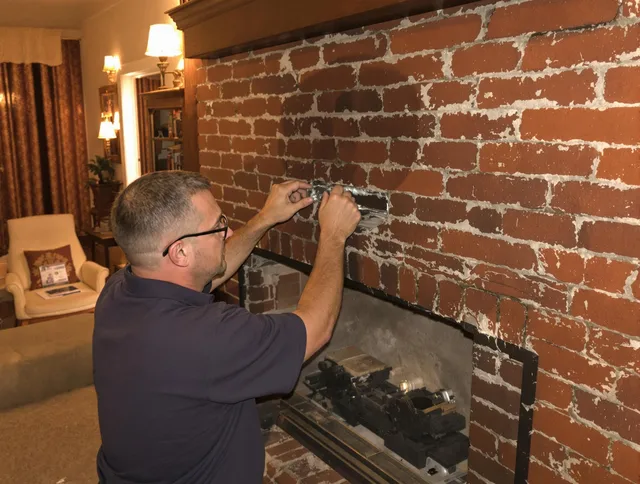 Sarasota Chimney Sweep expert fixing a fireplace in Sarasota, FL